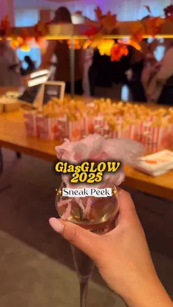 Attendees enjoying cocktails and churros at the VIP launch of GlasGLOW 2025 in Glasgow's Botanic Gardens.