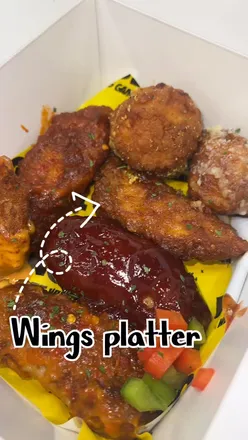 Wings 101 in Birmingham, showcasing garlic Parmesan wings and a vibrant dining atmosphere.