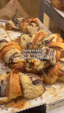 Delicious viral cookie croissant 'crookie' from Boulangerie Louvard in Paris, France, garnished with a cookie.
