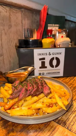 Two diners enjoying Korean Fried Cauliflower and Scotch Egg at Innis & Gunn, Glasgow, with steak frites for main course.