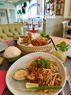 Diners enjoying bold Thai dishes and cocktails at Giggling Squid in Leamington Spa, surrounded by beautiful decor.