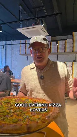 Delicious New York-style pizza with pepperoni, jalapeños, and hot honey at Paulie's London, celebrating city vibes!