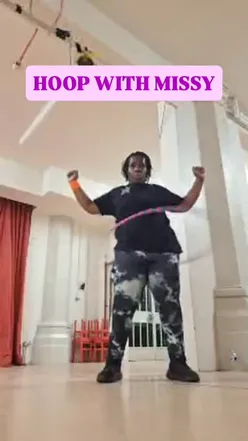 Excited participants in a hoop fitness class celebrating the return of fun, low-impact workouts.