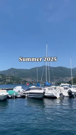 Person enjoying a cozy drink with colorful leaves, expressing reluctance for autumn's arrival.