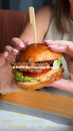 Enjoying a delicious crispy chicken burger and house fries during bottomless brunch at Canary Bar in Leeds.