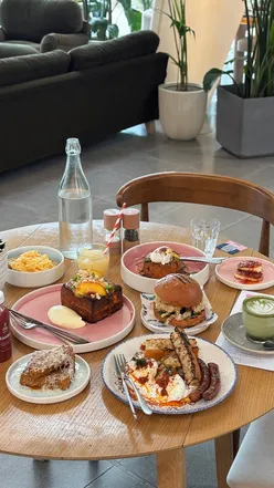 Brunch at the Friends of Ours in Hyde Park featuring vibrant dishes and coffee in a scenic setting.