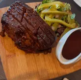 Delicious brisket dish enjoyed at The Queen Inn in Cwmbran, featuring a cute Labradoodle.