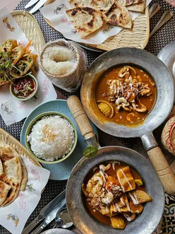 Enjoying a Thai feast with curries, spring rolls, and matcha cheesecake at Giggling Squid in Harpenden.