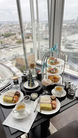 Afternoon tea at Ting London, featuring stunning skyline views and the Shard of the Sea dessert in a dramatic presentation.