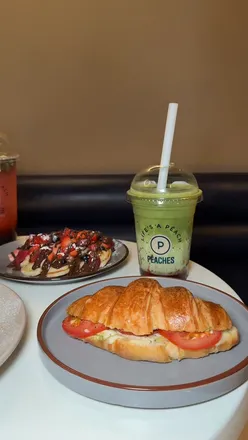 Delicious desserts at Peaches in Bethnal Green, featuring waffles, French toast, and bubble tea in a cozy café setting.