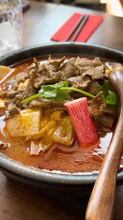 Group enjoying a vibrant hot pot meal at Pot Pot Malatang in Bristol, celebrating Asian culinary traditions.