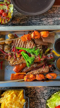 Smoke & Dough restaurant in Chelmsford, showcasing a chic interior and mixed grill menu with various meats and desserts.