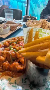 Delicious dishes at My Lahore: butter chicken, naan, and desserts showcasing authentic Pakistani flavors in Birmingham.