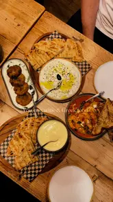 Enjoying authentic Greek and Cypriot dishes, including Stifado and halloumi, at Mythos in Chapel Allerton, Leeds.