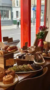 Participants enjoying pastries and coffee during Notting Hill bakery crawl round 2 in London.