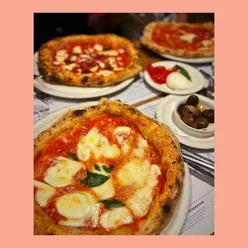 Friends enjoying delicious pizza at Paesano, a top spot for vibrant dining in Glasgow.