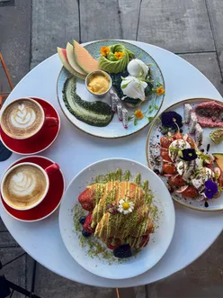 Brunch lovers enjoying pistachio croissants at Cloud 7 in Edgware, known for generous portions and quality dishes.