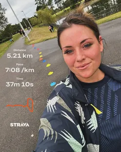 Runner celebrating a new personal best at Parkrun, reflecting on the humor of running in a lively atmosphere.