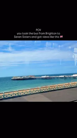 Scenic bus journey from Brighton to Seven Sisters, showcasing lush green hills and stunning sea views.