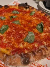 Delicious NY style pizza with rich sauce from Gracey's Pizza, a must-try for pizza lovers in London.