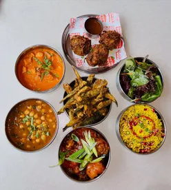 Delicious Indian street food dishes at Bundobust in Liverpool, featuring bhel puri, okra fries, and paneer kadai.