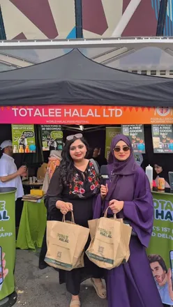 Attendees enjoying halal cuisine at the World Halal Food Festival, highlighting the TotalE Halal app for food delivery.