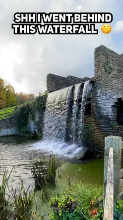 Waterfall behind Newstead Abbey, Lord Byron's home, surrounded by lush gardens and scenic beauty in Nottinghamshire.
