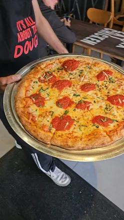 Delicious pizzas at the Pitfire Slice Bar pre-launch in Leicester, featuring unique flavors and halal options.