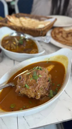 Brunch at My Abbottabad in Bradford featuring Chana, Halwa, Puri, Nihari, Paya, and fresh orange juice.