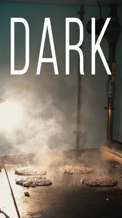 Delicious Dark Burger served at a trendy eatery, open Thursday to Monday, 5PM to midnight—come enjoy the dark side!