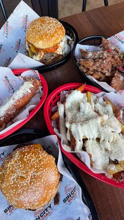 Three tomatoes stroll down Smithdown Rd, capturing the fun vibe of @sincitysocial_uk's burger joint atmosphere.