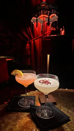 Intimate speakeasy bar in Soho featuring cocktails and small plates, perfect for a stylish night out.