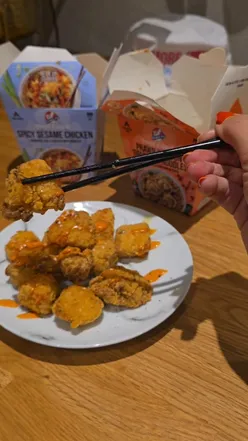 Couple enjoying a vibrant Thai night in with Kitchen Joy's new frozen dishes from Tesco, featuring flavorful meals and sides.