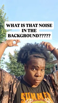 Person reacting to video playback, noticing hair out of place, capturing a humorous moment.