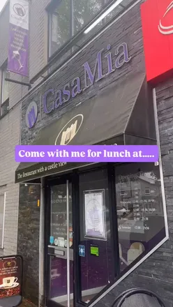 Delicious lunch at Casa Mia in Caerphilly with a stunning view of the castle; featuring hummus, prawns, lasagne, and chicken.