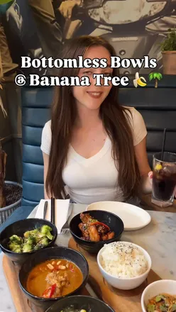 Enjoying diverse small plates at Banana Tree with beef, dumplings, and Masaman curry in a cozy evening setting.