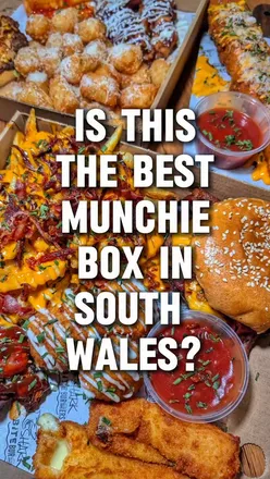 Delicious munchie box featuring burgers, loaded fries, BBQ wings, and milkshake from Shark Bite Burgers in Cwmbran.