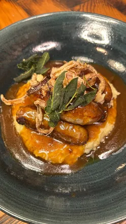 Autumn menu at The Boat features gourmet dishes like garlic Camembert, lobster crumpet, and flat iron steak in a stylish setting.