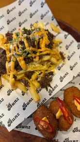 Delicious September specials at Bunz: birria loaded fries, gooey croquetas, and a refreshing mango mojito mocktail.