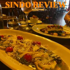 Dining experience at a restaurant, highlighting modern reservations via smartphones in a bustling setting.