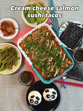 Delicious cream cheese salmon sushi tacos served with bao bun and fried asparagus, featuring fresh ingredients and vibrant colors.