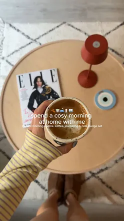 Cozy autumn morning routine with coffee, journaling, and reading at home.