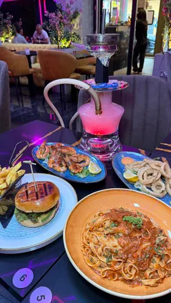 Delicious grilled prawns, calamari, beef ragu, and lobster burger at W Lounge, Croydon. Great vibes and service!