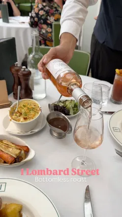 Enjoying a Sunday roast with drinks and desserts at 1 Lombard Street, featuring delicious crème brûlée and pavlova.