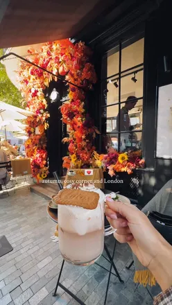 Brunch at Tom Tom Coffee featuring a green folded omelette amidst sunny weather and cozy layers with friends.