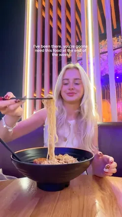 Students enjoying ramen bowls at Maki & Ramen in Leeds for just £5, promoting Freshers Flu event.