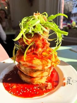 Delicious Frumpets and Korean fried chicken stack at Oeuf Cafe, a must-visit brunch spot in Hove for dog lovers!