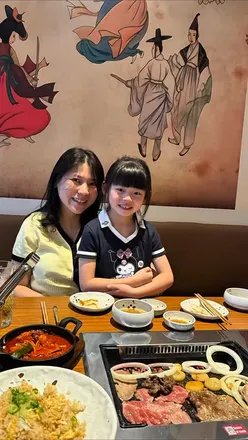 Josie grilling beef bulgogi and Iberico pork at Korean BBQ in Imperial Wharf, enjoying a family-friendly dining experience.