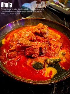 Diners enjoying Nigerian dishes like egusi, beef suya, and eba at Eko77 in Wolverhampton, West Midlands.