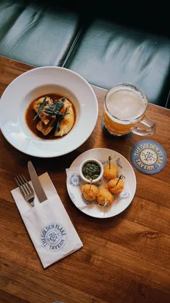 Friends enjoying Flakey pastries and drinks at Greggs, highlighting a festive atmosphere.